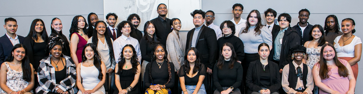 Loyola University Chicago's Leadership Scholars Programs students pose smiling for a photo during an End of Year Celebration event. The group is dressed in semi-formal attire.